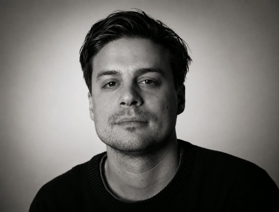 Daniel Kontur, founder of Tiny Realms Studios, in a black-and-white studio portrait.